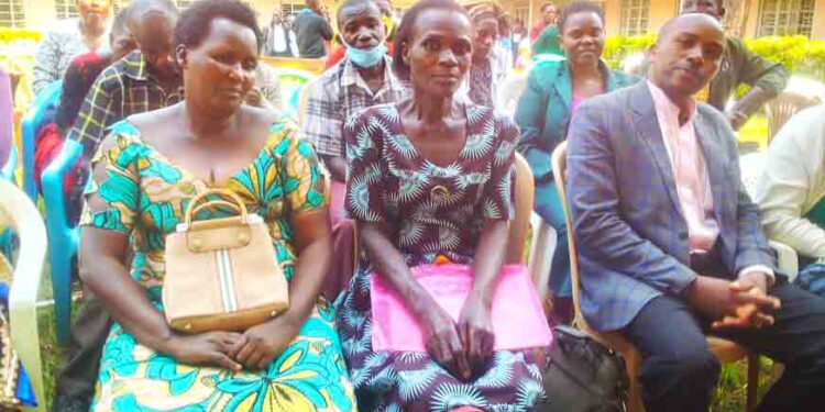 Nursing assistants and COPE teachers meet with Kisoro CAO Hajji Badru Mayanja over their sealed fate.