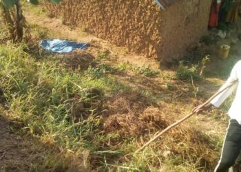 Icyimanizanye's body covered by a cloth