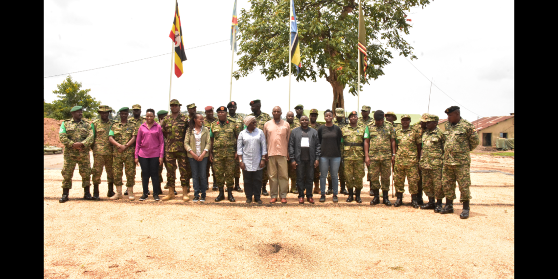The team poses for a group photo with the officers at the Contingent Headquarters