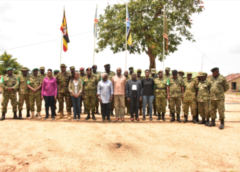 The team poses for a group photo with the officers at the Contingent Headquarters