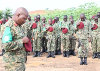Contingent Commander Col Michael Walaka Hyeroba leads his men in obseerving a momet of silence in respect for the fallen peacekeeper
