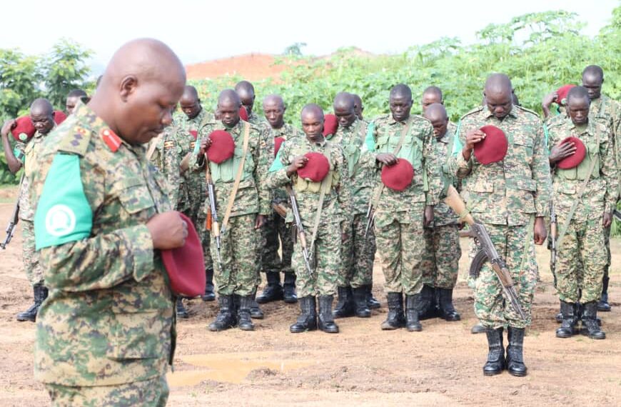 Contingent Commander Col Michael Walaka Hyeroba leads his men in obseerving a momet of silence in respect for the fallen peacekeeper