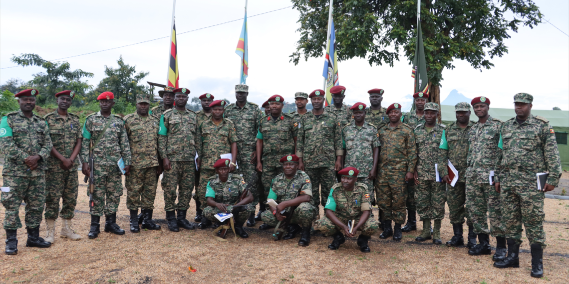 Ugacon Commander ,Col Micheal Walaka Hyeroba [middle] the Deputy Commander Lt col Frank Tumwesigye and the contico Admin Staff pose for a group photo with some officers