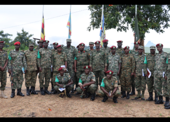 Ugacon Commander ,Col Micheal Walaka Hyeroba [middle] the Deputy Commander Lt col Frank Tumwesigye and the contico Admin Staff pose for a group photo with some officers