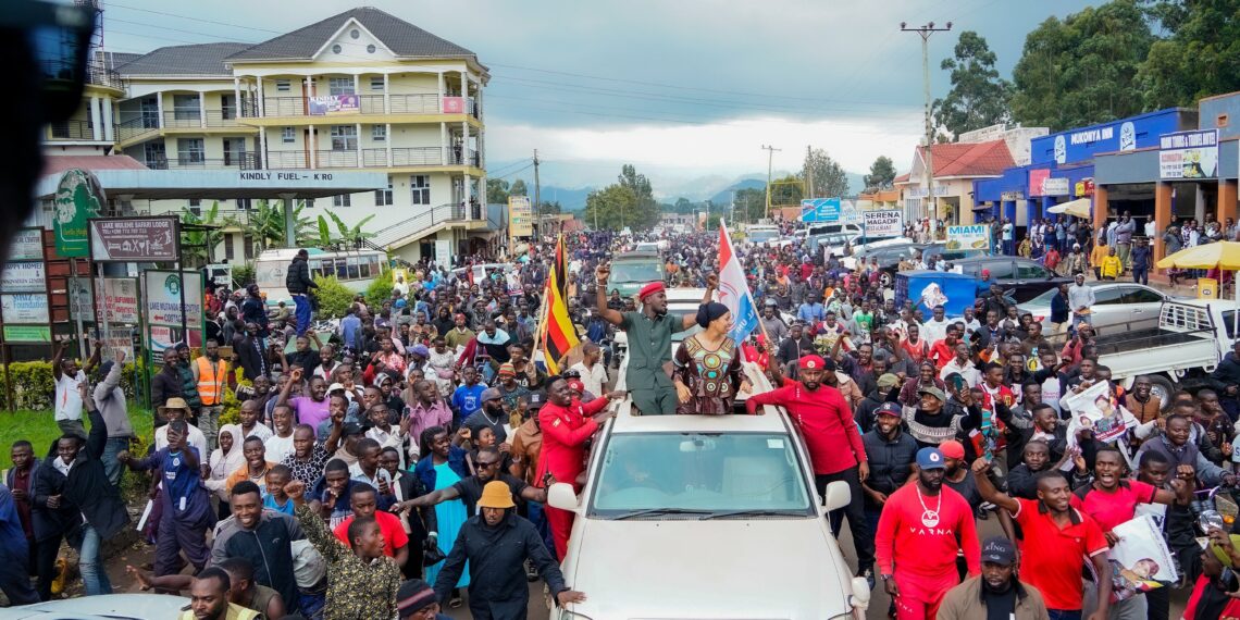 Bobi Wine and Tana Mukankwaya are followed by crowds on Kisoro Main Street on Thursday October 25, 2024